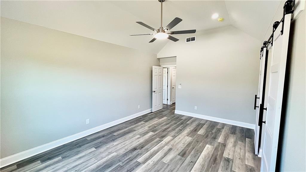 5 Green Road Griffin, GA 30224 - Photo 19 of 34 a view of a room with wooden floor and a ceiling fan