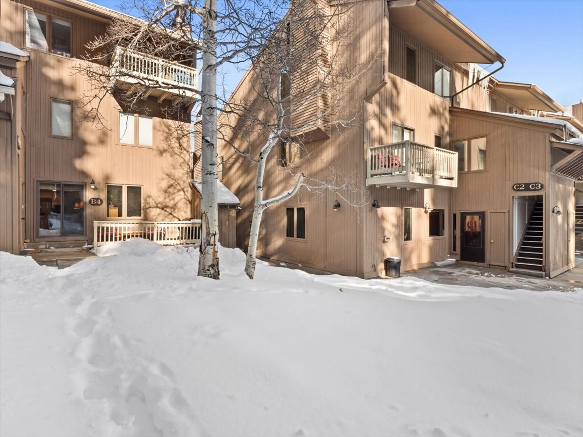 108 Guller Road, Unit B4 Frisco, CO 80443 - Photo 2 of 21 Snow covered property with a view of apartment building / complex and stairway