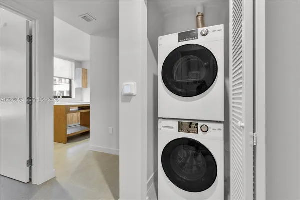 a view of a hallway with washer and dryer