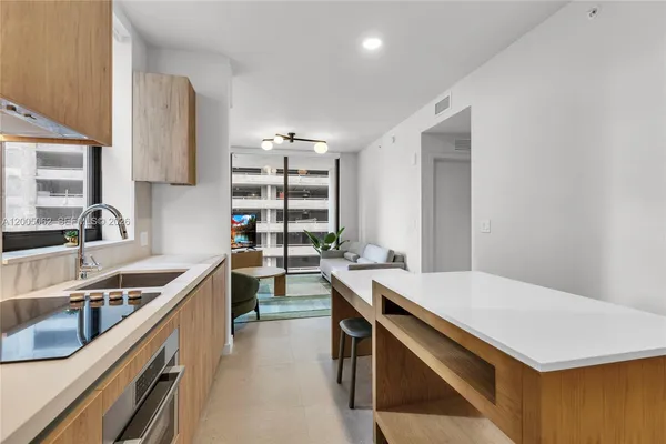 a kitchen that has a sink a stove and a table
