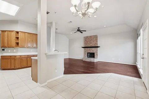 a living room with stainless steel appliances kitchen island granite countertop furniture and a fireplace