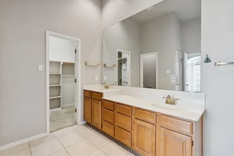 a bathroom with a sink double vanity and a mirror