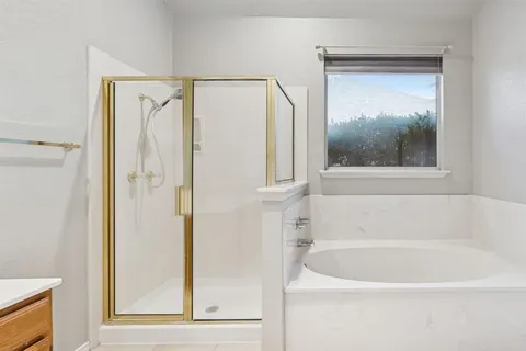 a white bath tub sitting next to a shower
