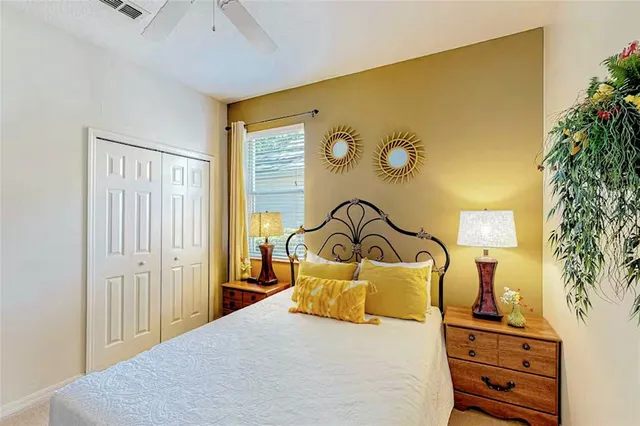 a bedroom with a bed and dresser with mirror