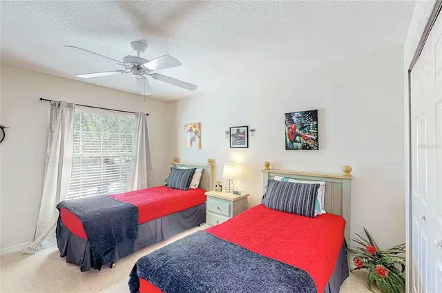 a bedroom with two beds and a window