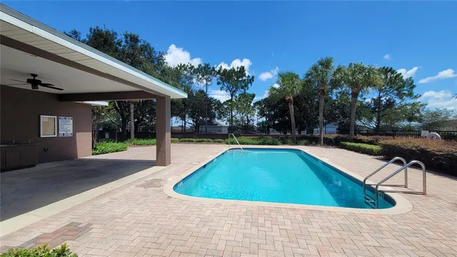 a view of swimming pool with chairs