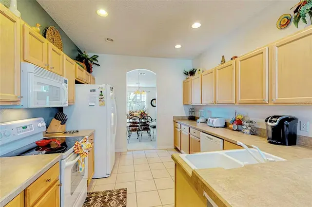 a kitchen with a sink a stove and cabinets