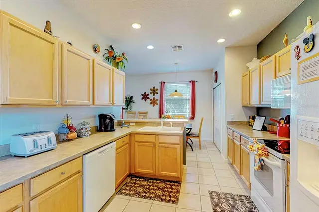 a kitchen with a sink a stove and cabinets