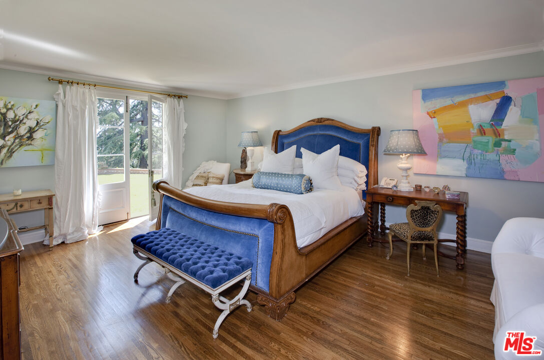 7 Oakmont Drive Los Angeles, CA 90049 - Photo 7 of 14 a bedroom with a bed a dresser and wooden floor