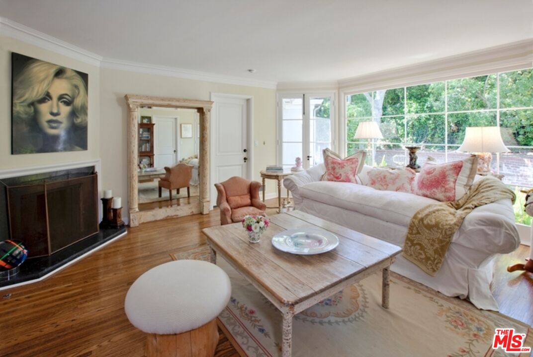 7 Oakmont Drive Los Angeles, CA 90049 - Photo 8 of 14 a living room with furniture a fireplace and a table