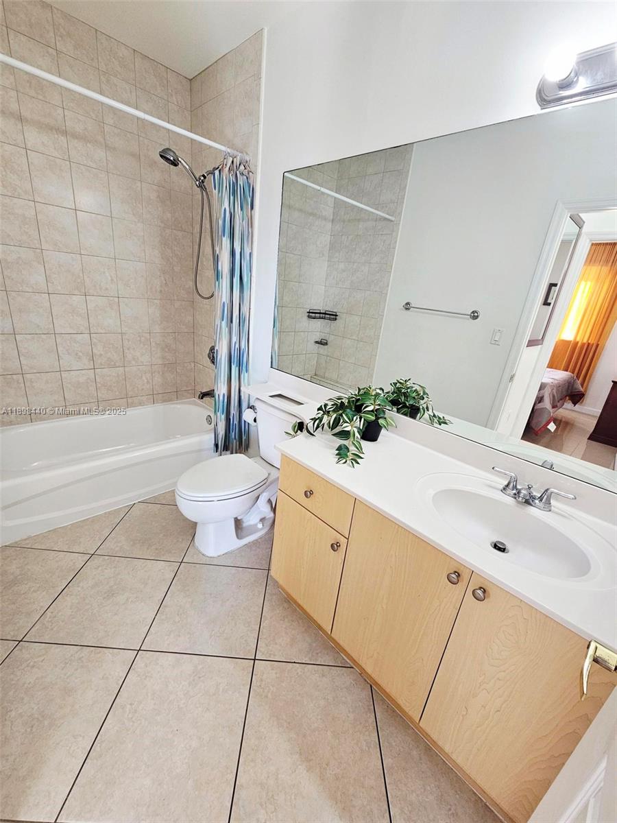 2280 Southwest 32nd Avenue, Unit 511 Miami, FL 33145 - Photo 11 of 17 a bathroom with a double vanity sink mirror and shower