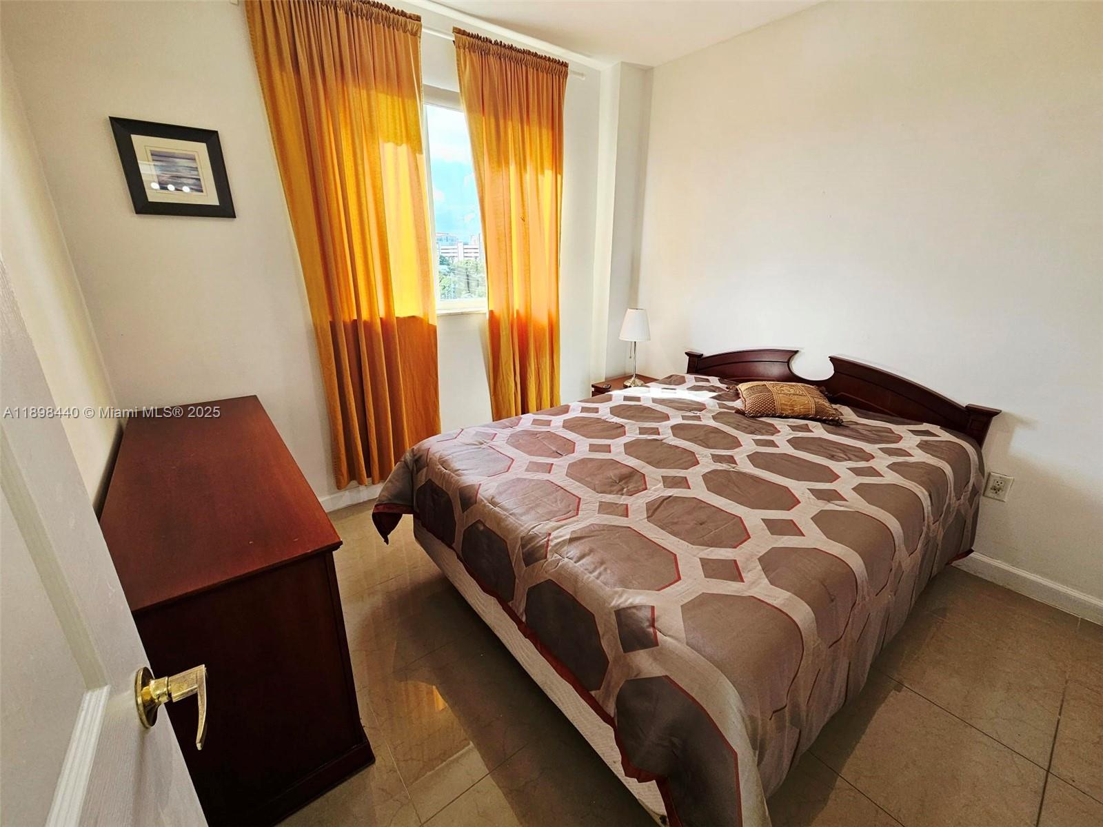 2280 Southwest 32nd Avenue, Unit 511 Miami, FL 33145 - Photo 10 of 17 a bedroom with a bed and wooden floor