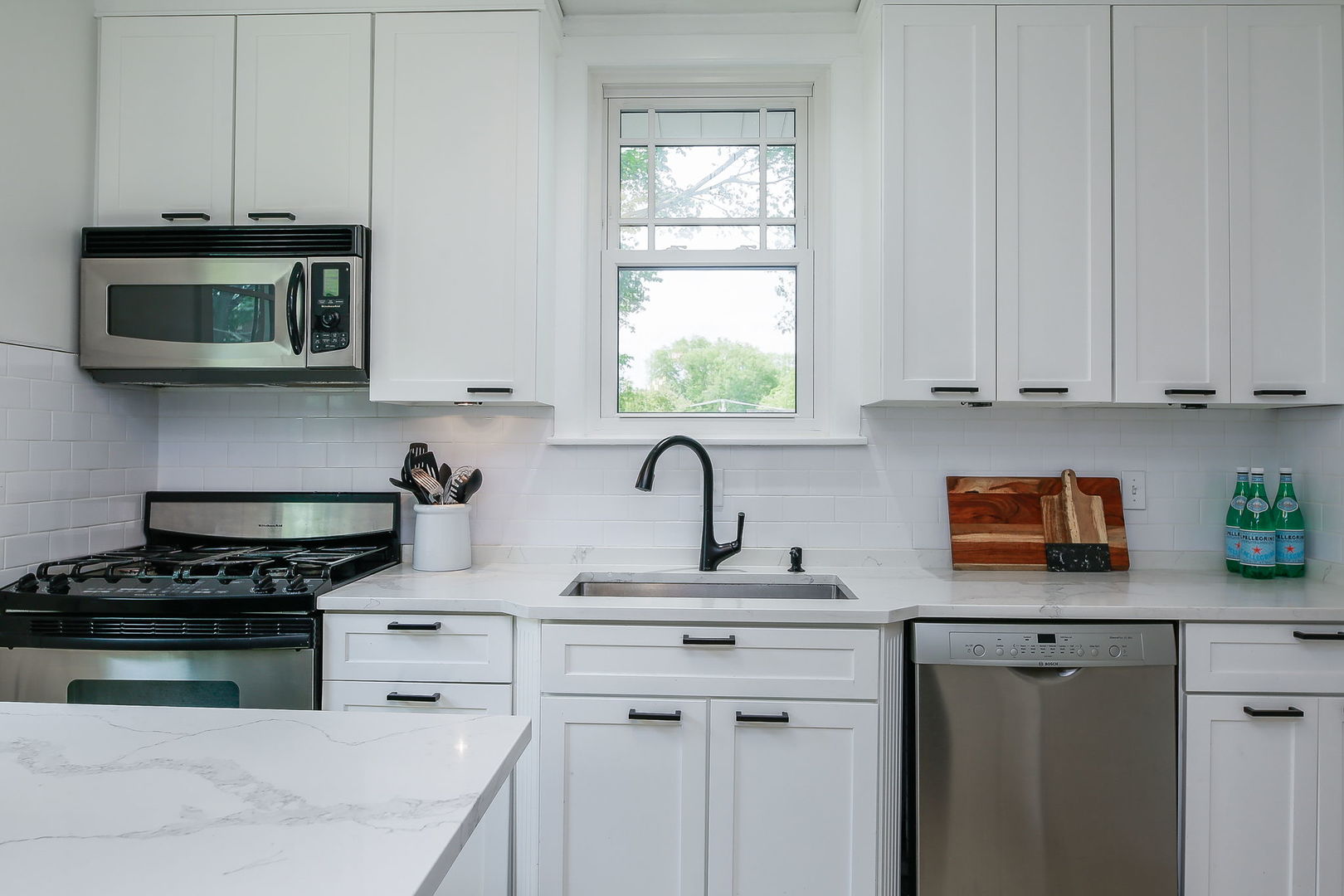 429 East Illinois Street Wheaton, IL 60187 - Photo 11 of 30 a kitchen with white cabinets and appliances