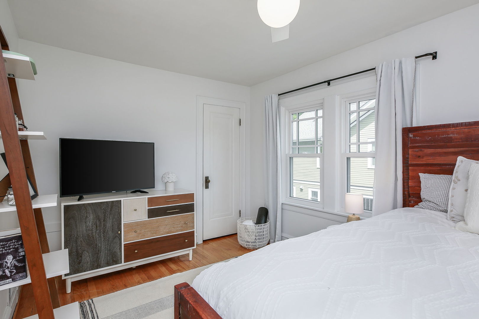 429 East Illinois Street Wheaton, IL 60187 - Photo 15 of 30 a bedroom with a bed and a flat screen tv