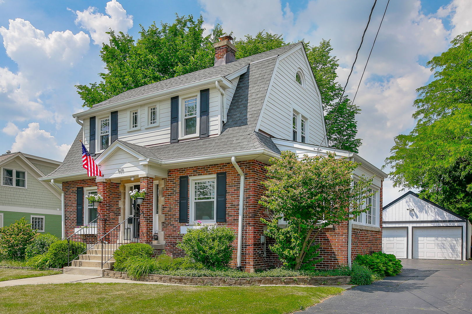 429 East Illinois Street Wheaton, IL 60187 - Photo 2 of 30 a front view of a house with garden