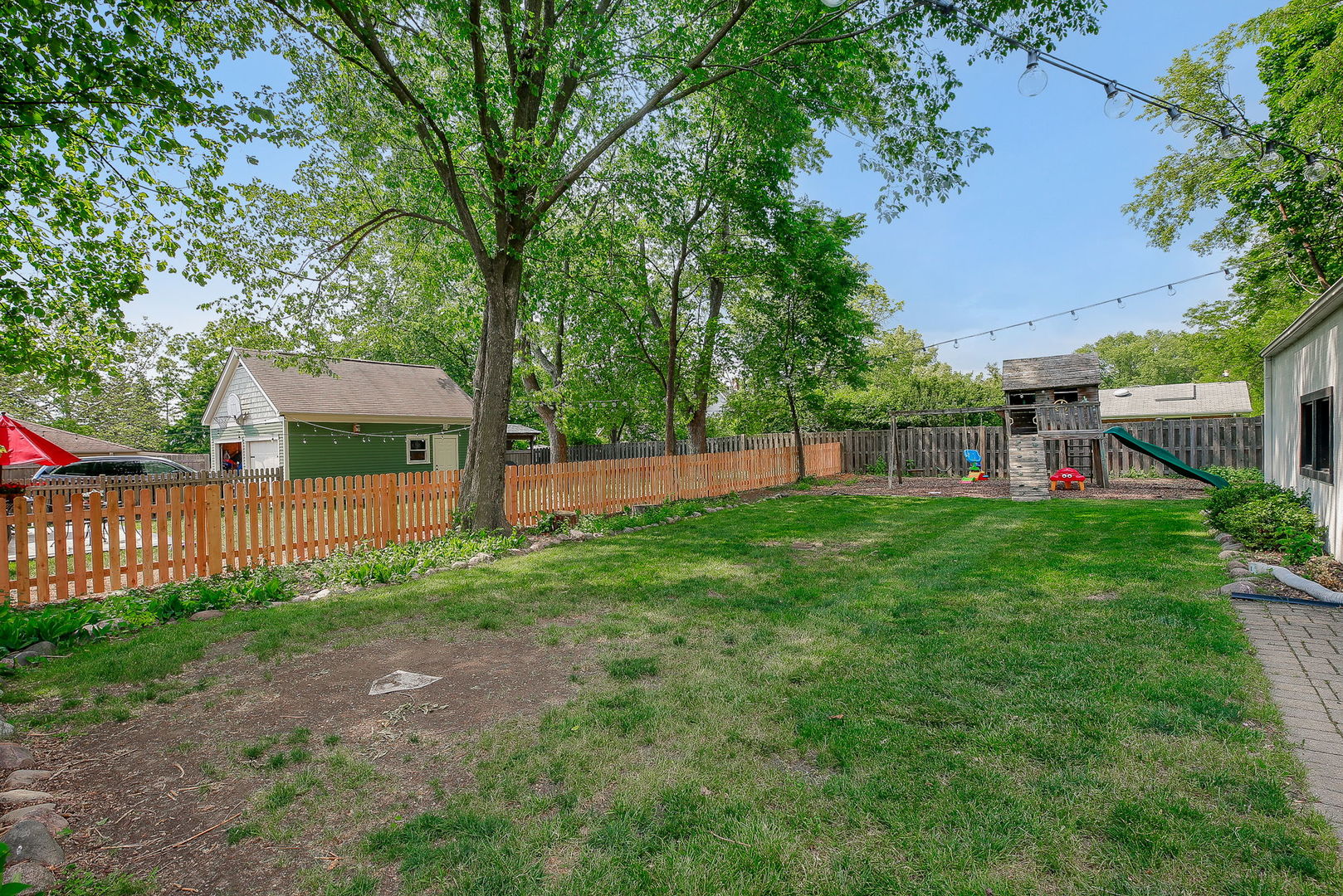429 East Illinois Street Wheaton, IL 60187 - Photo 25 of 30 a view of a house with a yard and a garden