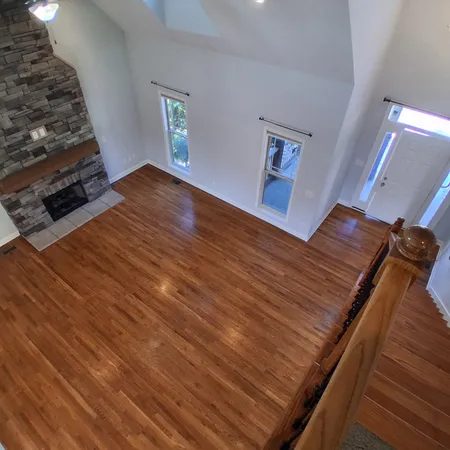 a view of an empty room with wooden floor