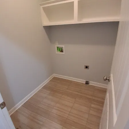 a view of a small space with wooden floor