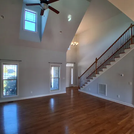 a view of entryway and hall with wooden floor