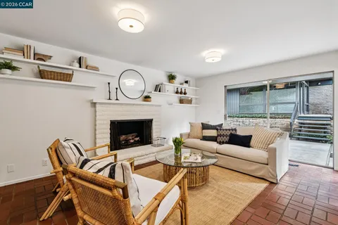 a living room with furniture a fireplace and a table