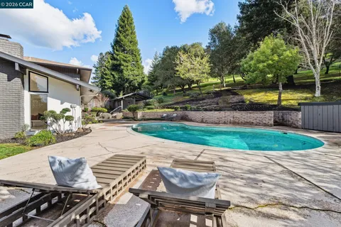 a view of couches in the patio with a fire pit