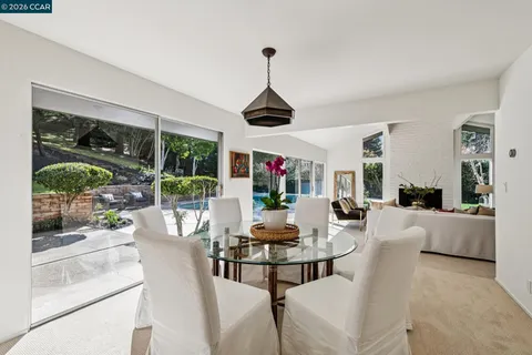 a dining room with furniture a chandelier and window