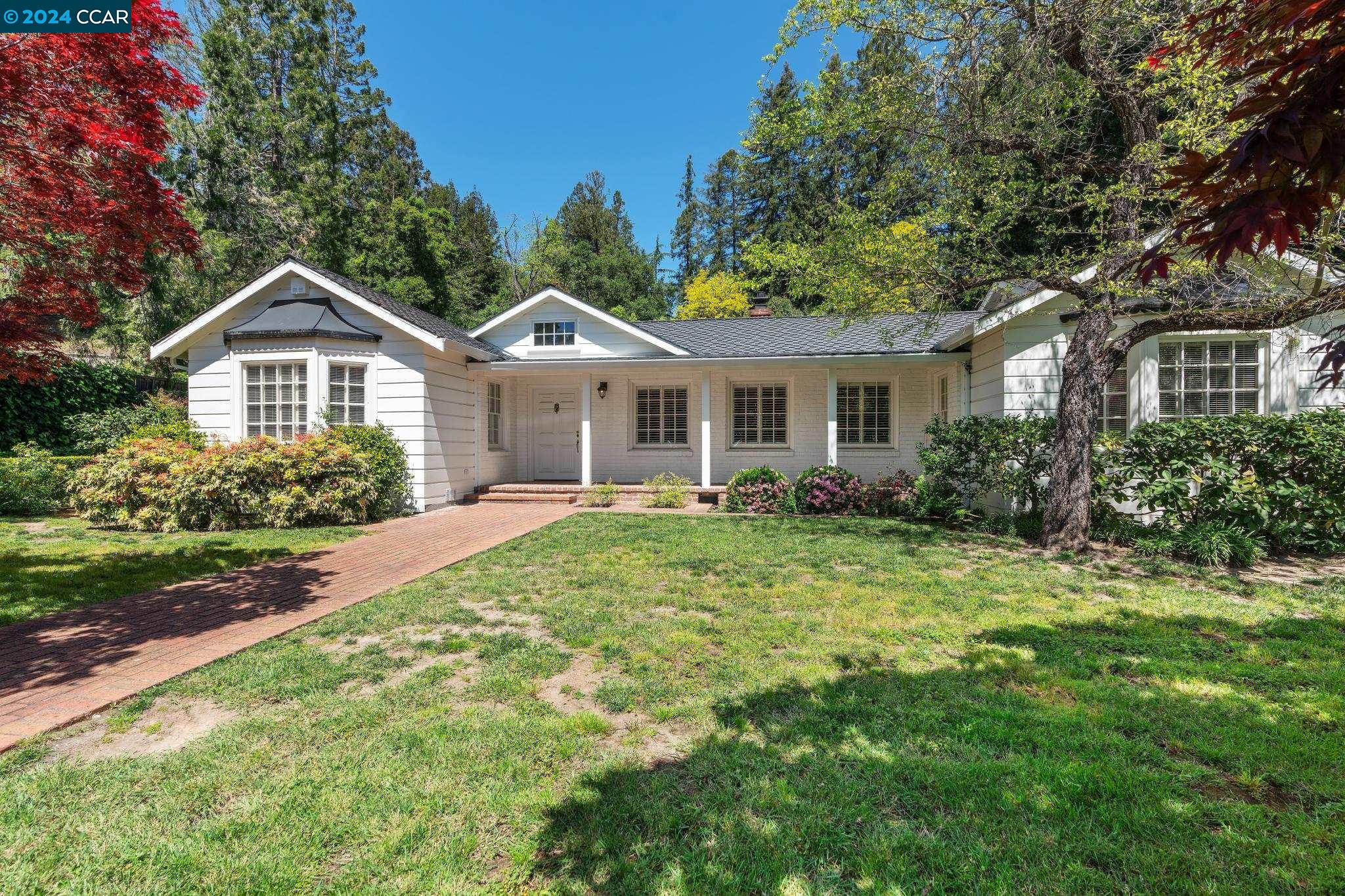 a front view of a house with garden