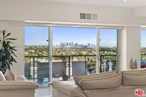 a living room with furniture and a floor to ceiling window