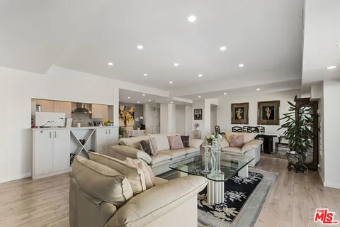 a living room with furniture or couch and a wooden floor