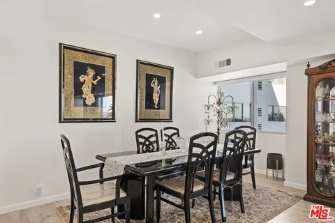 a view of a dining room and hall with furniture