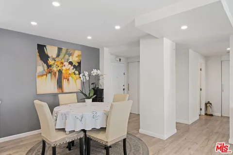 a view of a dining room with furniture wooden floor and window