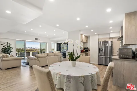a large kitchen with a table and chairs