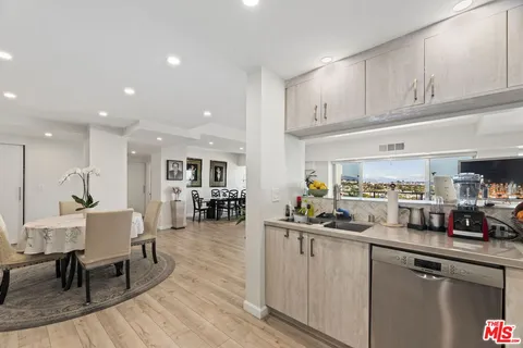 a kitchen with lots of counter top space and furniture