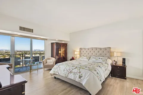 a bedroom with a large bed and a couch