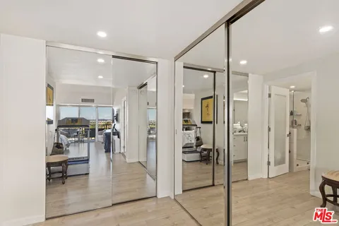 a view of a hallway with dining area and glass door