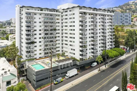a view of a balcony with a couple of cars parked in front of it