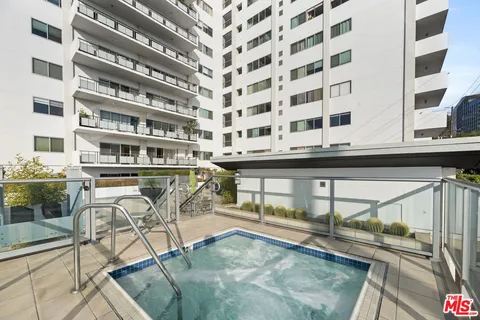 a view of a swimming pool with outdoor seating