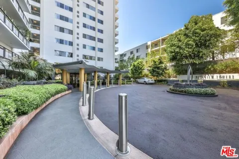 a view of a street with a building in the background