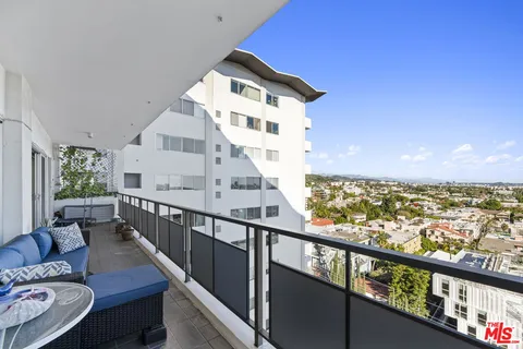 a view of a balcony with chair and wooden floor