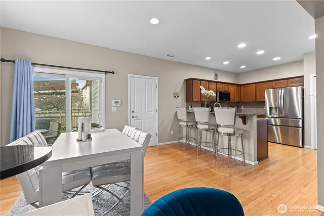 a large kitchen with lots of counter space a sink appliances and a dining table