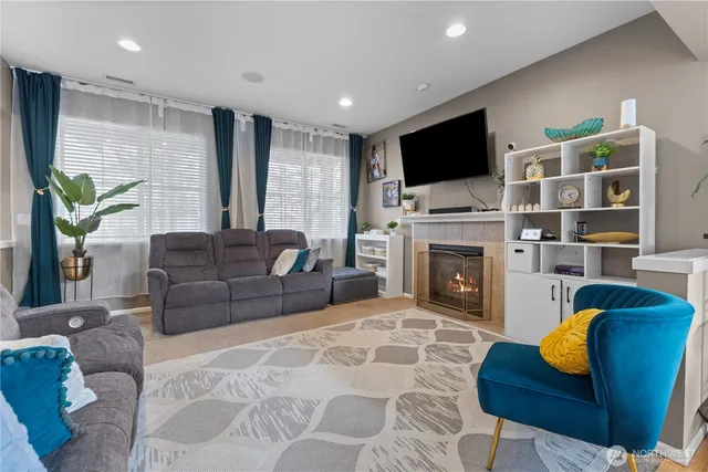 a living room with furniture fireplace and flat screen tv
