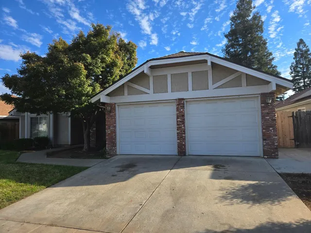 a front view of house with yard and trees