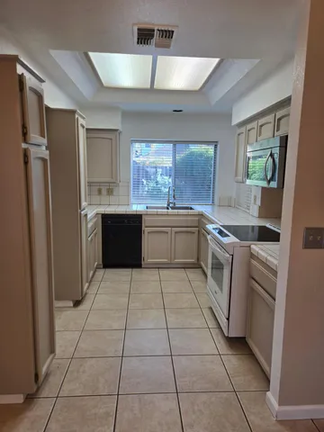 a large kitchen with cabinets and stainless steel appliances