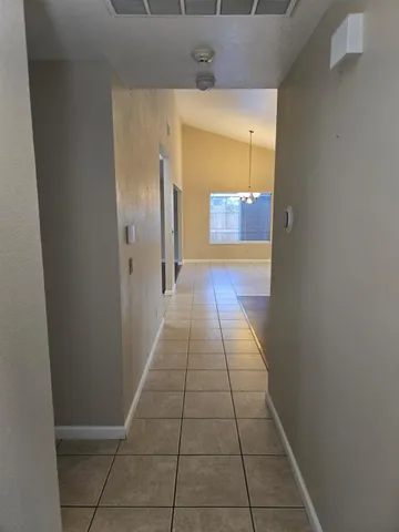 a hallway with view of a bathroom