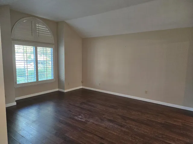 a view of wooden floor and windows in a room