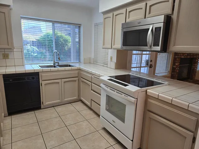 a kitchen with a stove a sink and a microwave