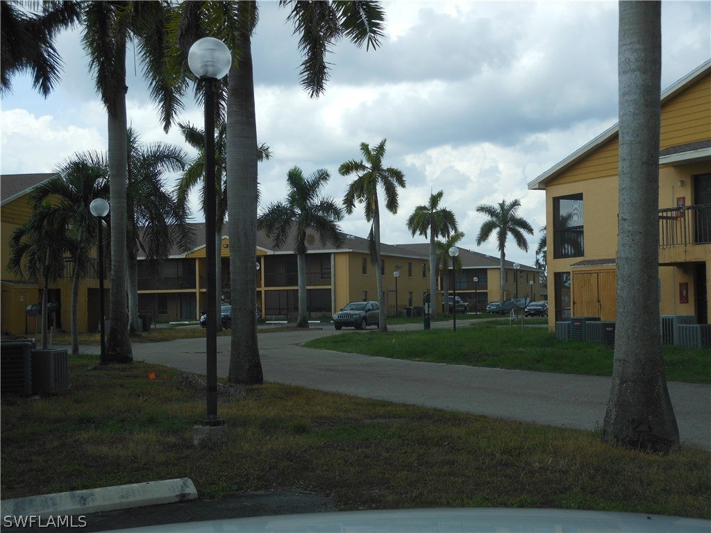 5311 Summerlin Road, Unit 1115 Fort Myers, FL 33919 - Photo 1 of 14 front view of house with a yard