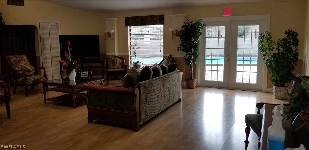 5311 Summerlin Road, Unit 1115 Fort Myers, FL 33919 - Photo 11 of 14 a living room with furniture and a flat screen tv