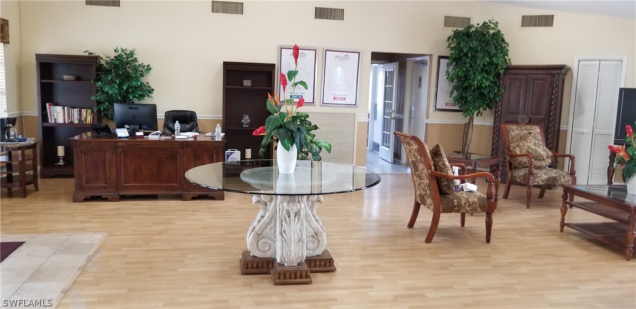 5311 Summerlin Road, Unit 1115 Fort Myers, FL 33919 - Photo 12 of 14 a dining room with furniture and a potted plants