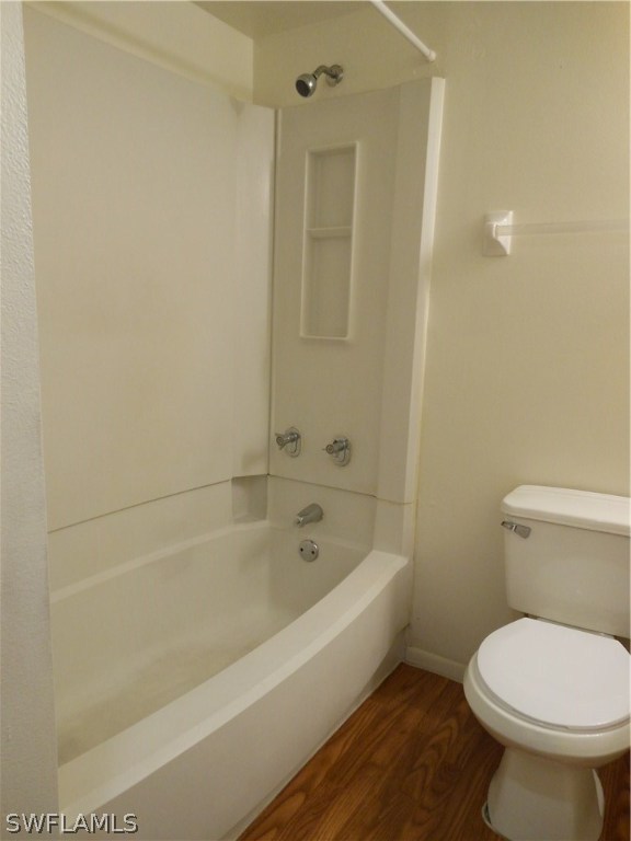 5311 Summerlin Road, Unit 1115 Fort Myers, FL 33919 - Photo 7 of 14 a white toilet sitting next to a bath tub